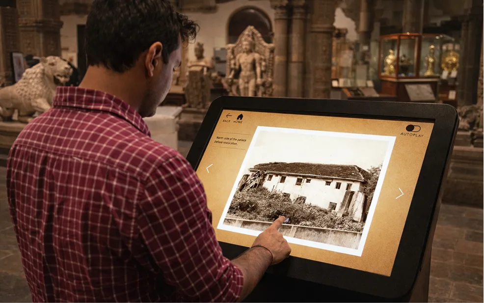 Interactive tilted touchscreen kiosk showing historical photography